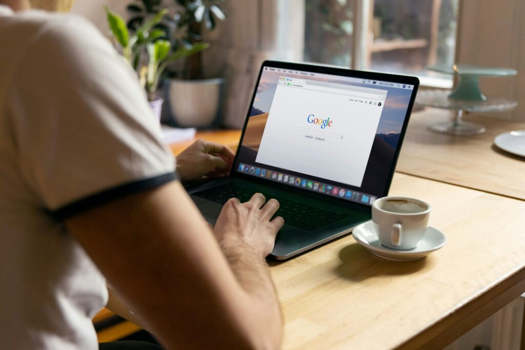 Person searching Google on a laptop